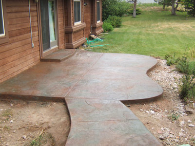 Small stamped concrete patio with walkway