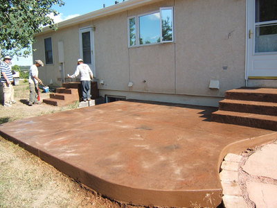 backyard stamped concrete patio with stairs