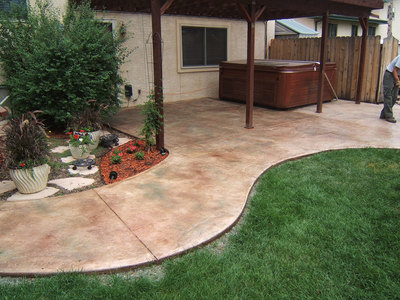 stamped concrete back patio with hot tub
