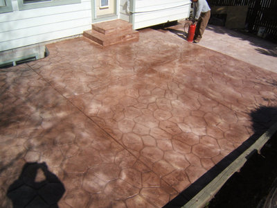 completing a new stamped concrete patio